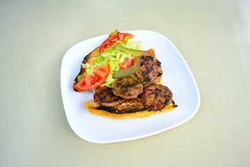 Meatball between bread (Turkish name : ekmek arasi kofte ) Izgara kofte. Manisa, Akcaabat, Akhisar  kofte. Delicious meat grilled meatballs.