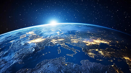 Obraz premium A glowing view of Earth at night from space, showing the lights of cities scattered across continents.