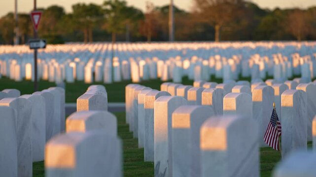 American army Sarasota National Cemetery with rows of white tombstones and USA flag on green grass. Memorial Day concept