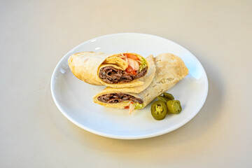 Lavash doner kebab ( soslu kasarli zurna doner durum )  or shawarma sliced in plate isolated. ...