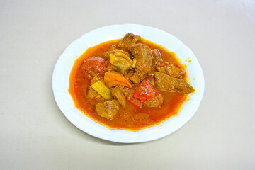 Turkish  Traditional Ramadan doner kebab with tasty tomato sauce and rice or turkish pilav in white plate on table background. Lavash doner kebab ( doner zurna durum )  Pilavustu Doner Iskender kebap
