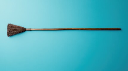 Simple Broom on Bright Blue Background for Cleaning and Home Use
