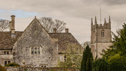 Fototapeta premium Old house and church in an English country village.