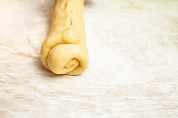 Yellow raw dough roll, soft focus close up abstract backdrop