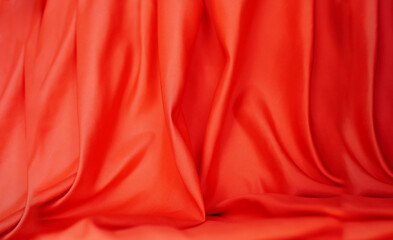 Orange background of satin or silk Elegant and beautiful (blurry or blurry)