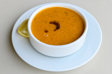 Turkish Ezo Gelin soup, Traditional Turkish Soup. Geleneksel Ezogelin corbasi. Ezogelin Soup Served with a slice of lemon. Top view