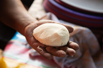 Preparing corn tortillas by hand for traditional quesadillas in the Oaxaca region of Mexico.