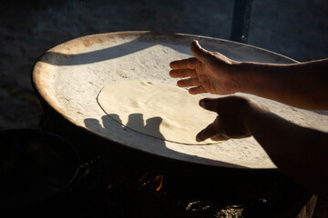 Preparing corn tortillas by hand for traditional quesadillas in the Oaxaca region of Mexico.