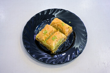Turkish Dessert Sobiyet, havuc dilimi, midye baklava, mussels baklava and classic baklava with Pistachio . Cikolatali cevizli, fistikli soguk Baklava, top view.