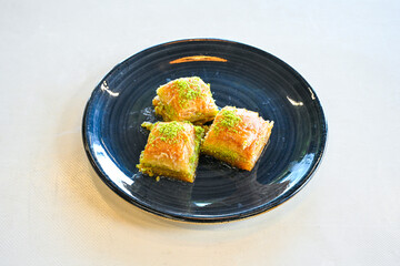 Turkish Dessert Sobiyet, havuc dilimi, midye baklava, mussels baklava and classic baklava with Pistachio . Cikolatali cevizli, fistikli soguk Baklava, top view.