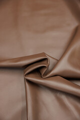 Leather texture: Elegant folds and shading A representation of high quality leather with visible...