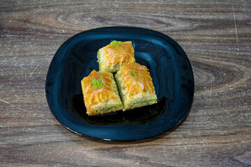 Turkish Dessert Sobiyet, havuc dilimi, midye baklava, mussels baklava and classic baklava with Pistachio . Cikolatali cevizli, fistikli soguk Baklava, top view.