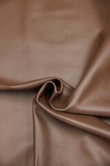 Leather texture: Elegant folds and shading A representation of high quality leather with visible wrinkles and shading that highlight the softness and structure of the material.