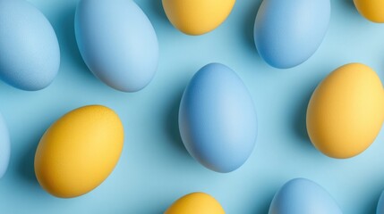 A collection of blue and yellow eggs on a blue surface, ideal for illustrations or design concepts