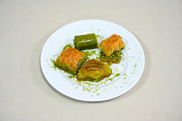 Turkish Dessert Sobiyet, havuc dilimi, midye baklava, mussels baklava and classic baklava with Pistachio . Cikolatali cevizli, fistikli soguk Baklava, top view.