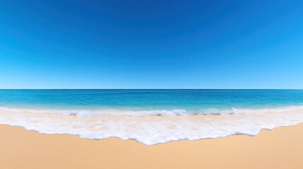 Serene beach scene with clear blue sky and gentle waves.