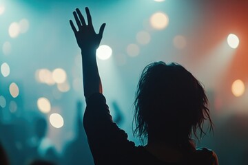 A person celebrates with raised hands, conveying happiness and accomplishment