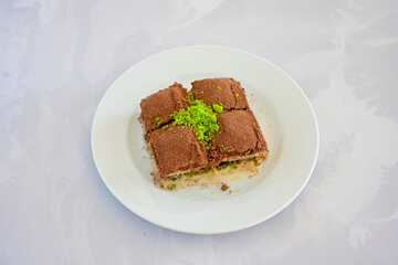 Turkish Dessert Sobiyet, havuc dilimi, midye baklava, mussels baklava and classic baklava with Pistachio . Cikolatali cevizli, fistikli soguk Baklava, top view.