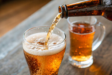a glass of beer being poured into a glass