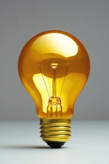 A single yellow light bulb sits on top of a table, providing warm and cozy lighting