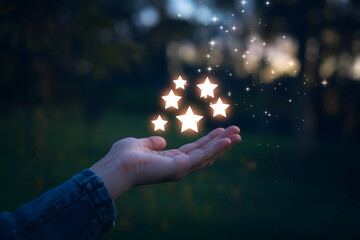 Hand emits glowing stars, symbolizing creativity, hope, and inspiration against dark backdrop