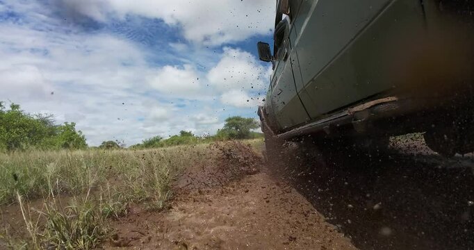 A 4x4 or safari car drives through flooded roads