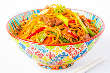 a bowl of noodles with meat and vegetables