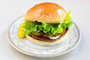 Big tasty burger with beef cutlet on a plate. Hamburger, cheeseburger with mushroom. Hamburger, Mexica, mushroom double burger.  Crispy chicken burger. With french fries, patates kizartmasi.