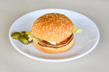 Big tasty burger with beef cutlet on a plate. Hamburger, cheeseburger with mushroom. Hamburger, Mexica, mushroom double burger.  Crispy chicken burger. With french fries, patates kizartmasi.