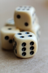 Dice on beige background with shallow depth of field and copy space
