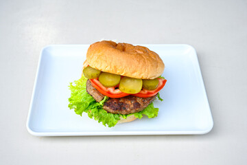 Big tasty burger with beef cutlet on a plate. Hamburger, cheeseburger with mushroom. Hamburger, Mexica, mushroom double burger.  Crispy chicken burger. With french fries, patates kizartmasi.