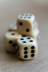 dice on a beige background, close-up 