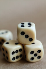 dice on a beige background, close-up 