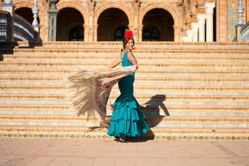 Fototapeta premium the gorgeous girl dances in the sun with the beautiful Flamingo dress