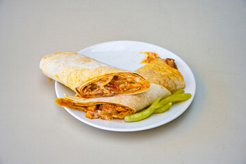 Lavash doner kebab ( soslu kasarli zurna doner durum )  or shawarma sliced in plate isolated.  Tavuk Et Doner Durum. Hatay Iskenderun usulu bazuka, zurna  tavuk doner durum. 