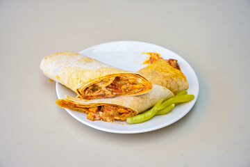 Lavash doner kebab ( soslu kasarli zurna doner durum )  or shawarma sliced in plate isolated.  Tavuk Et Doner Durum. Hatay Iskenderun usulu bazuka, zurna  tavuk doner durum. 