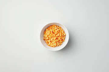 Bright orange cereal in white bowl creates vibrant and inviting