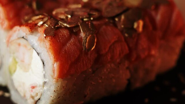 Sushi rotates on a board on a black background. Sushi concept. Fresh rolls on a black background. 4k