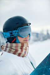 A Mountain Range Reflected In The Ski Mask. Winter Sports. Woman At The Ski Resort On The Background Of Mountains And Blue Sky