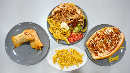 Traditional Turkish cuisine. Pizza, pita, pidesi, sucuk, hummus, kebab. Many dishes on the table. Serving dishes in restaurant. Margherita,  mix, formaggi, veggie karisik pizza. Top view, flat lay
