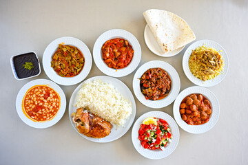 Delicious meat kebab with fresh vegetable salad served with variety of Turkish dishes and appetizers. Top view of assorted Turkish food and meze, tasty and healthy Mediterranean cuisine.