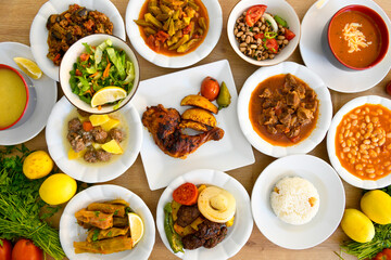 Delicious meat kebab with fresh vegetable salad served with variety of Turkish dishes and appetizers. Top view of assorted Turkish food and meze, tasty and healthy Mediterranean cuisine.