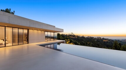 Fototapeta premium Modern architecture with an infinity pool overlooking a sunset view.