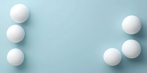 Five white spheres arranged on a light blue background, leaving space for text or design elements.