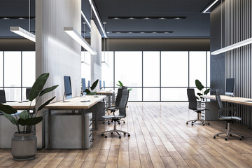 Modern office interior with desks, chairs, and computers near large windows overlooking city view. Spacious design with wooden flooring. 3D Rendering