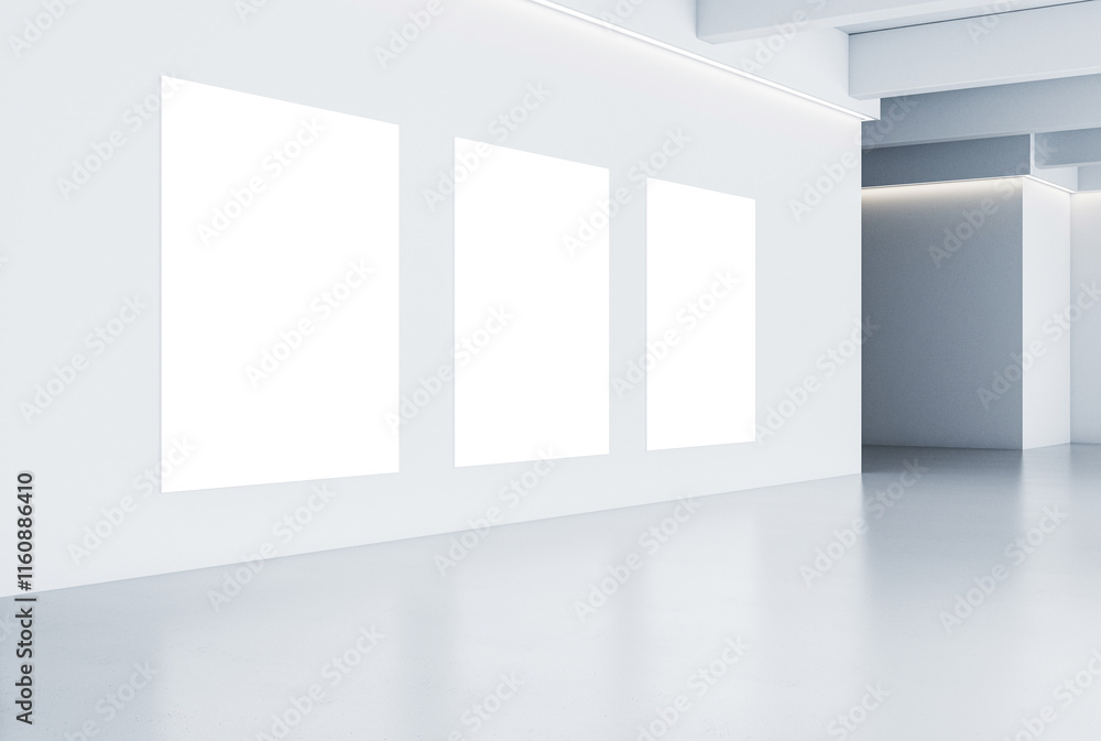 Poster blank white gallery room with three empty rectangular frames on a clean white wall, modern interior 