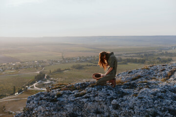 Woman sitting on cliff edge admiring valley below, travel adventure beauty nature meditation trip landscape scenic view