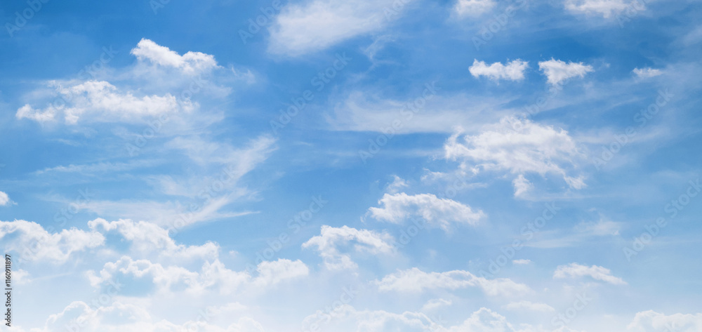 Wall mural the sky is blue with a few clouds scattered throughout