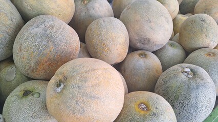 a bunch of melons in the fruit shop