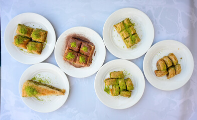 Turkish Dessert Sobiyet, havuc dilimi, midye baklava, mussels baklava and classic baklava with Pistachio . Cikolatali cevizli, fistikli soguk Baklava, top view.